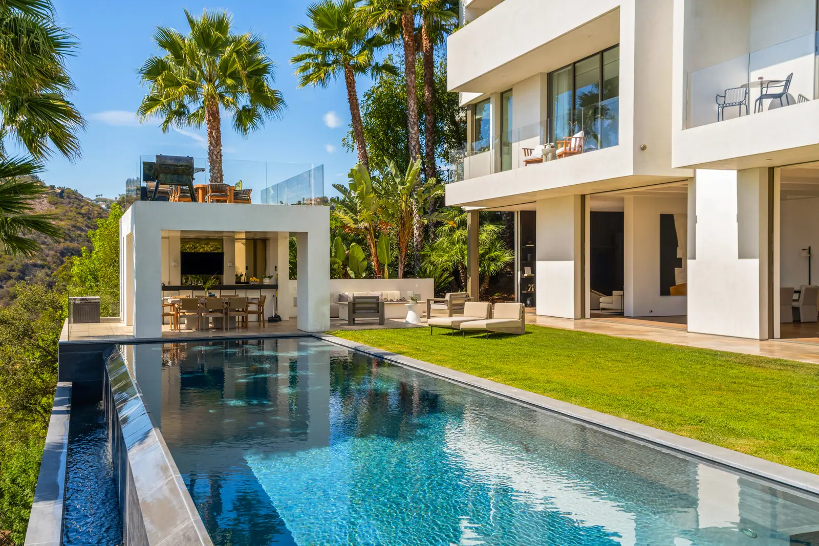 Pool and lawn with the house and pavilion behind