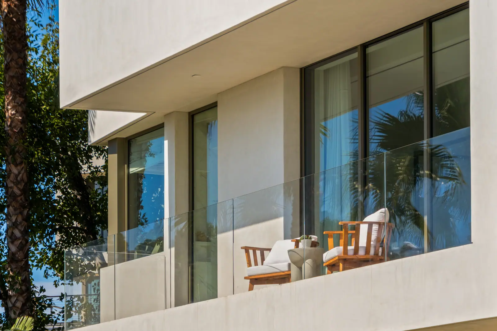 Plaster elevation detail with deep window reveals above the pool terrace