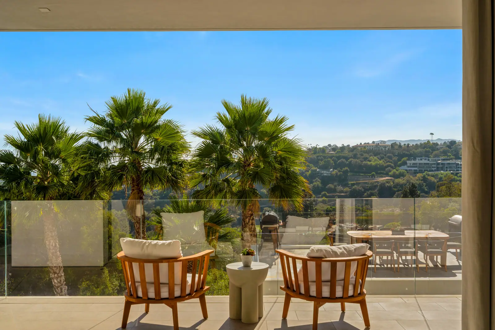 Primary terrace with two chairs and palms above the canyon