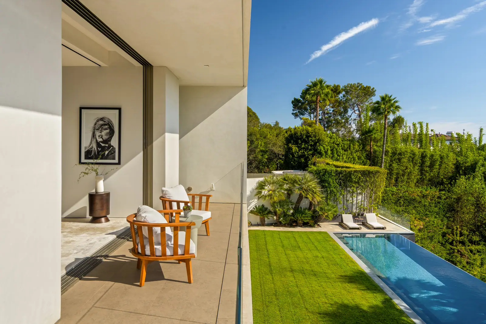 Terrace seating looking down over the pool and lawn