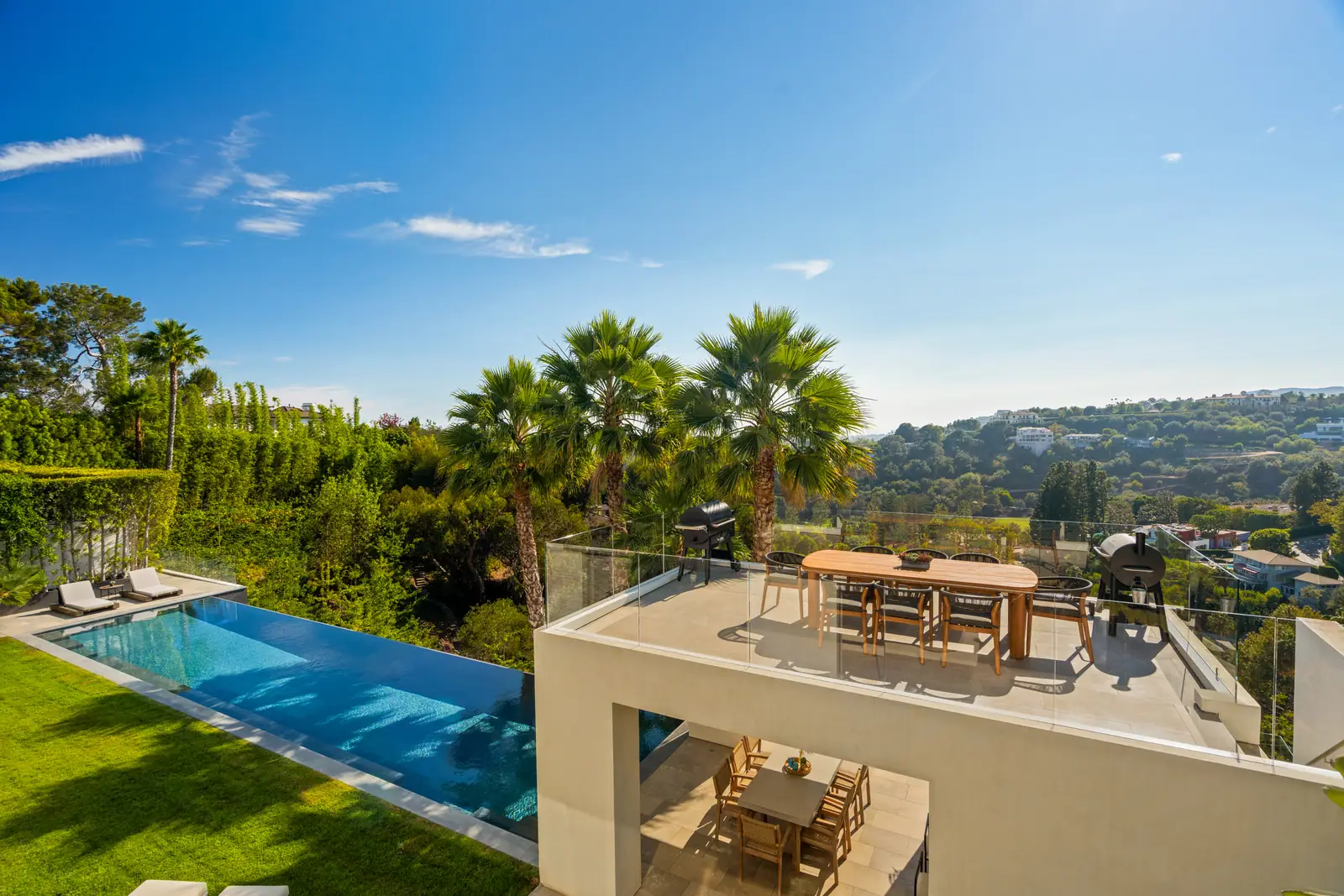 Roof terrace above the pool and lawn with the outlook beyond
