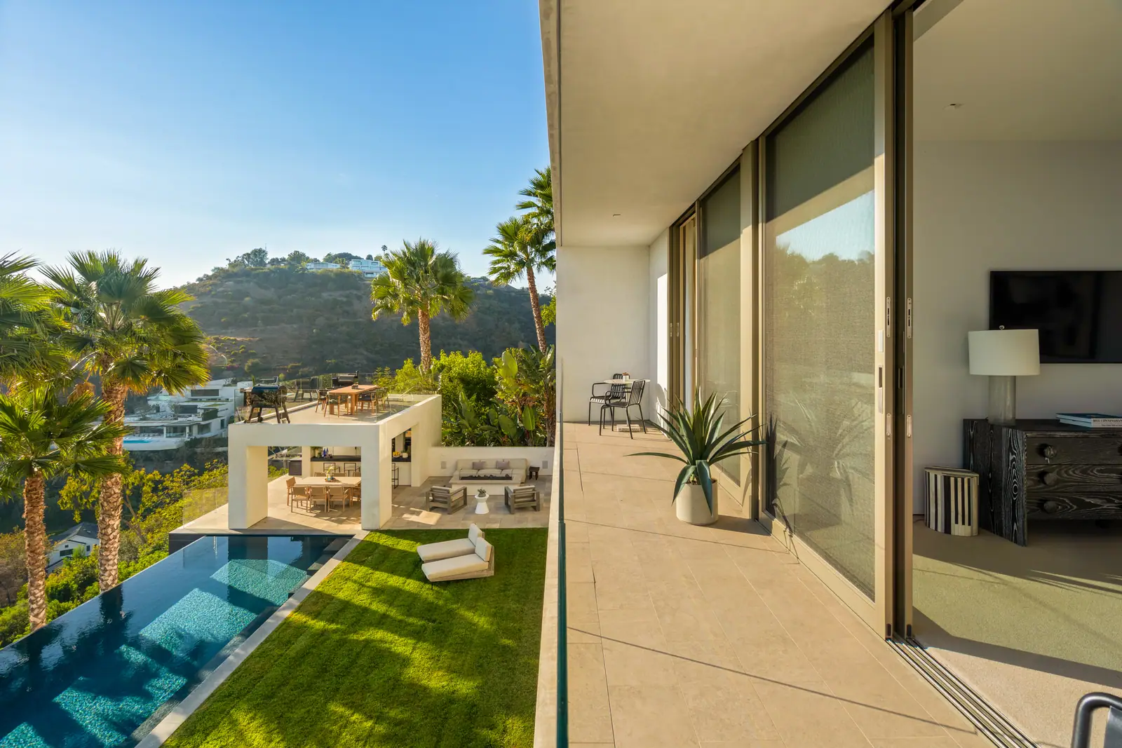Terrace looking down to the pool, lawn and pavilion